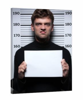 Busted burglar. Angry burglar holding a white poster while stand