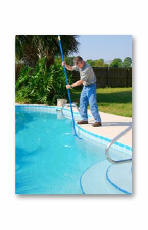 Residential pool cleaning service man working on a sparkling clean pool brushing the side clean