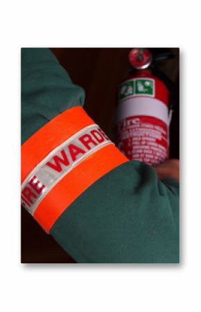 Fire warden with a reflective high visibility identification patch holding a fire extinguisher, Melbourne 2015