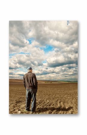 farmer on plowed spring field