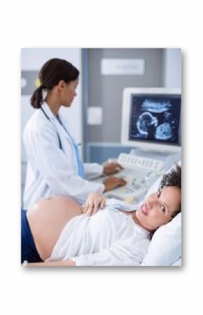 Doctor doing ultrasound scan for pregnant woman