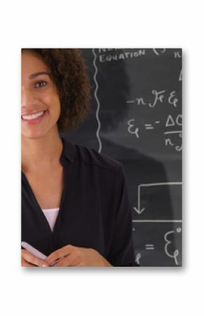 Portrait of black teacher giving math lesson on chalkboard