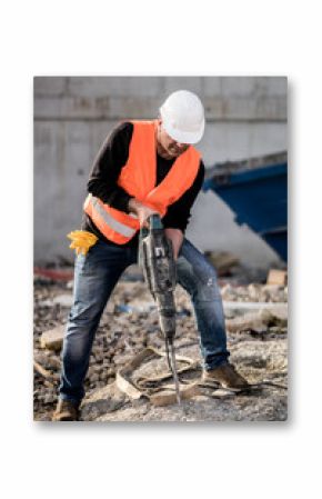 Male construction worker using a jackhammer on construction site