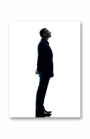 one caucasian business man standing profile silhouette isolated on white background