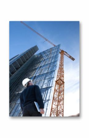 Architect,engineer with laptop,tablet on construction site checking building