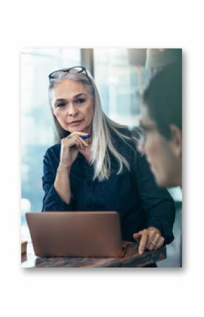 Mature business woman paying attention in meeting