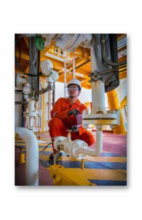 operator recording operation of oil and gas process at oil and rig plant, offshore oil and gas industry, offshore oil and rig in the sea, operator monitor production process, routine daily record.