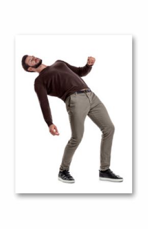 A bearded fit man in casual clothes stands with his back deeply bent backwards on a white background.