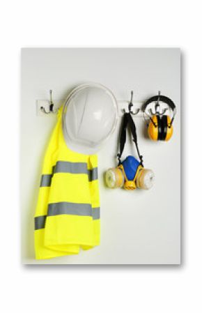 Different safety equipment hanging on white wall