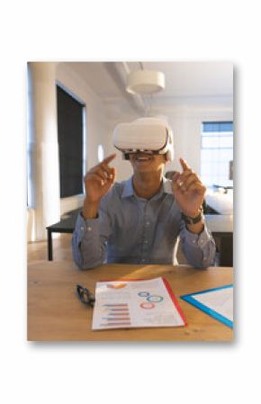 In office, businessman using VR headset interacting with virtual presentation documents