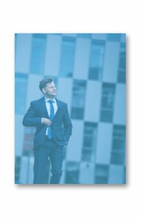 Businessman walking against building