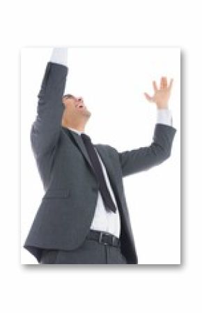 Excited businessman with arms raised