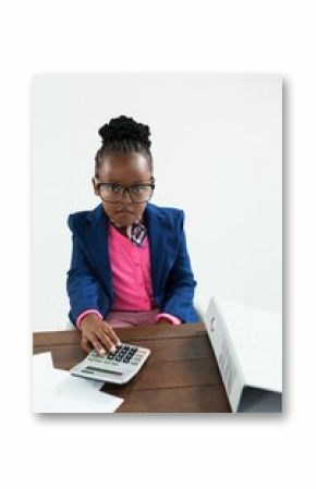Portrait of businesswoman using calculator