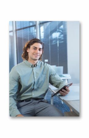 Business professional holding tablet, smiling confidently in modern office setting