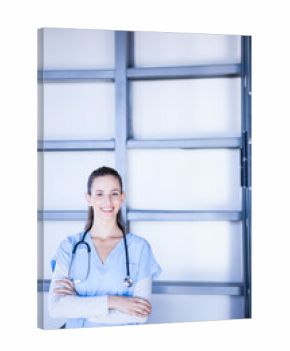 Female nurse standing before frosted glass panel with metal beams wearing blue scrubs stethoscope