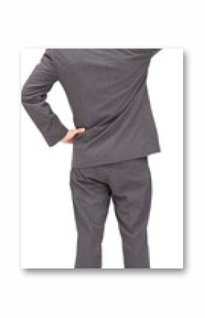 Young businessman standing back to camera scratching his head