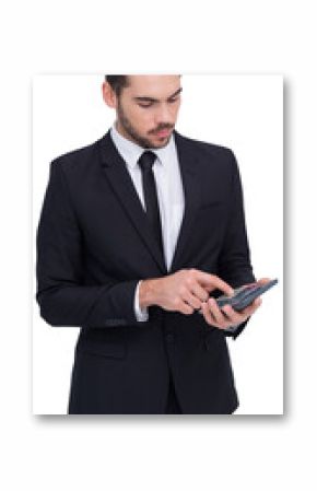 Concentrated businessman in suit using calculator 
