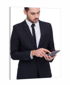 Concentrated businessman in suit using calculator 