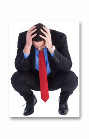 Worried businessman with head in hands