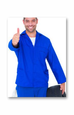 Mechanic with tire gesturing thumbs up
