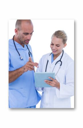 Medical professionals discussing while using tablet computer