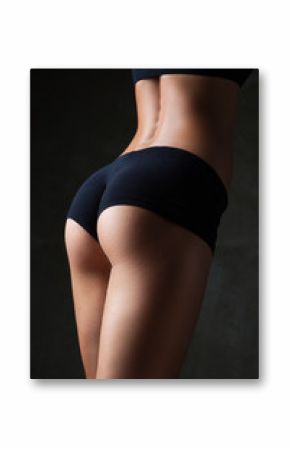Beautiful fit, sexy female body on dark grey