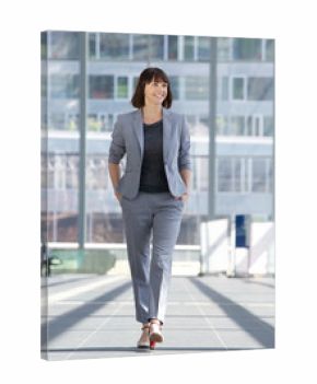 Relaxed business woman smiling and walking