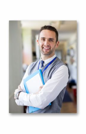 Happy Teacher Standing in Corridor