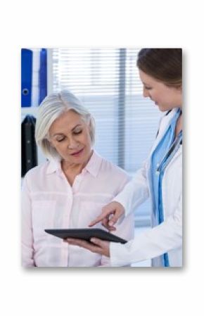 Doctor discussing with patient over digital tablet