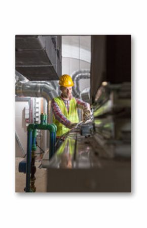 Worker making final touches to HVAC system. HVAC system stands for heating, ventilation and air conditioning technology. Team work, HVAC, indoor environmental comfort concept photo.