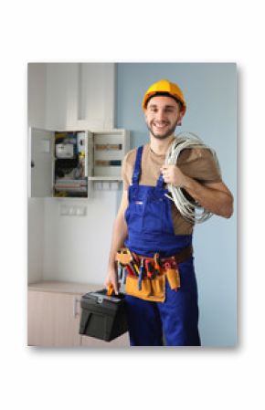 Young smiling electrician with bunch of wires indoors