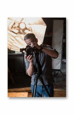 in the Studio the man in the process of photographing on the background of bright lighting equipment