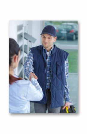 young housewife meeting service worker at the door at home