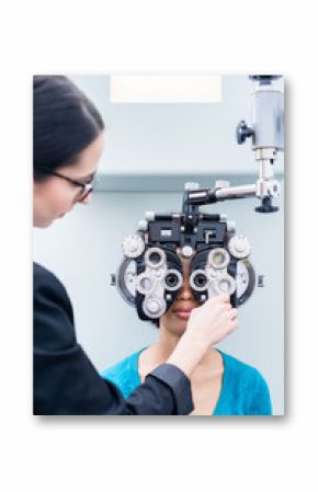 Optometrist and woman at eye examination with phoropter