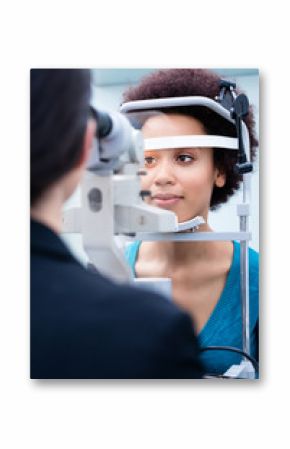 Optician measuring women eyes with refractometer in optician shop
