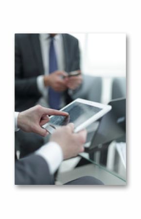 close up.the businessman uses a digital tablet in the workplace