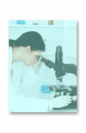 Female scientist looking through a microscope