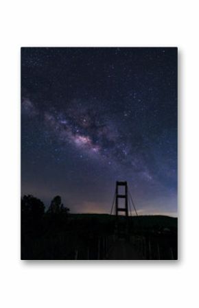 Milky way over rope bridge, Long exposure photograph.with grain