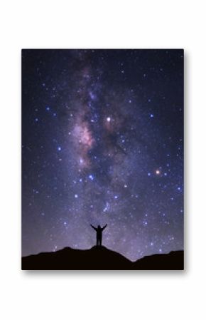 Milky way galaxy with stars and space dust in the universeand and silhouette of a standing happy man