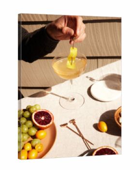 Person holding a cocktail glass among different foods