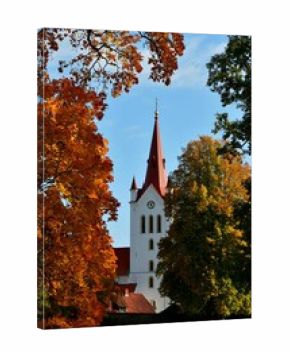 Vertical of the Saint John church in Cesis, Latvia surrounded by autumn foliage, fall colors
