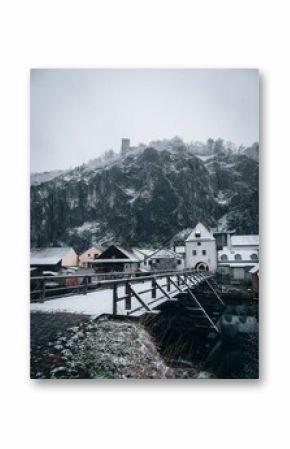 Vertical shot of a bridge with houses and mountains in the background, Kelheim, Germany