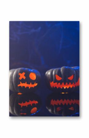 Vertical image of carved pumpkins with copy space on blue background
