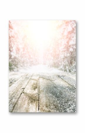 Empty wooden table at snowy winter forest during sunset