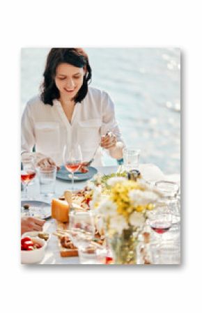 Young woman having dinner at a lake