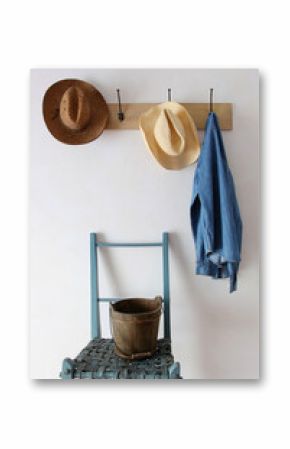 Straw hats and shirt  hanging on hooks