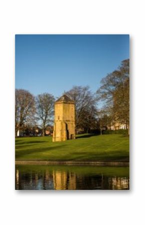 Vertical shot of the historic stone fortress tower in Abington Park, Northampton