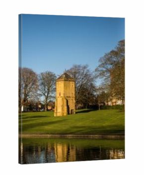 Vertical shot of the historic stone fortress tower in Abington Park, Northampton