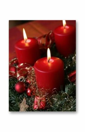 Vertical shot of red lighted Christmas candles for holidays