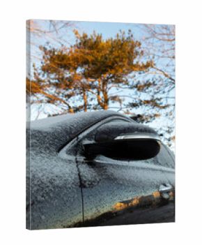 Car Covered in Light snow frost with side view mirror in driveway